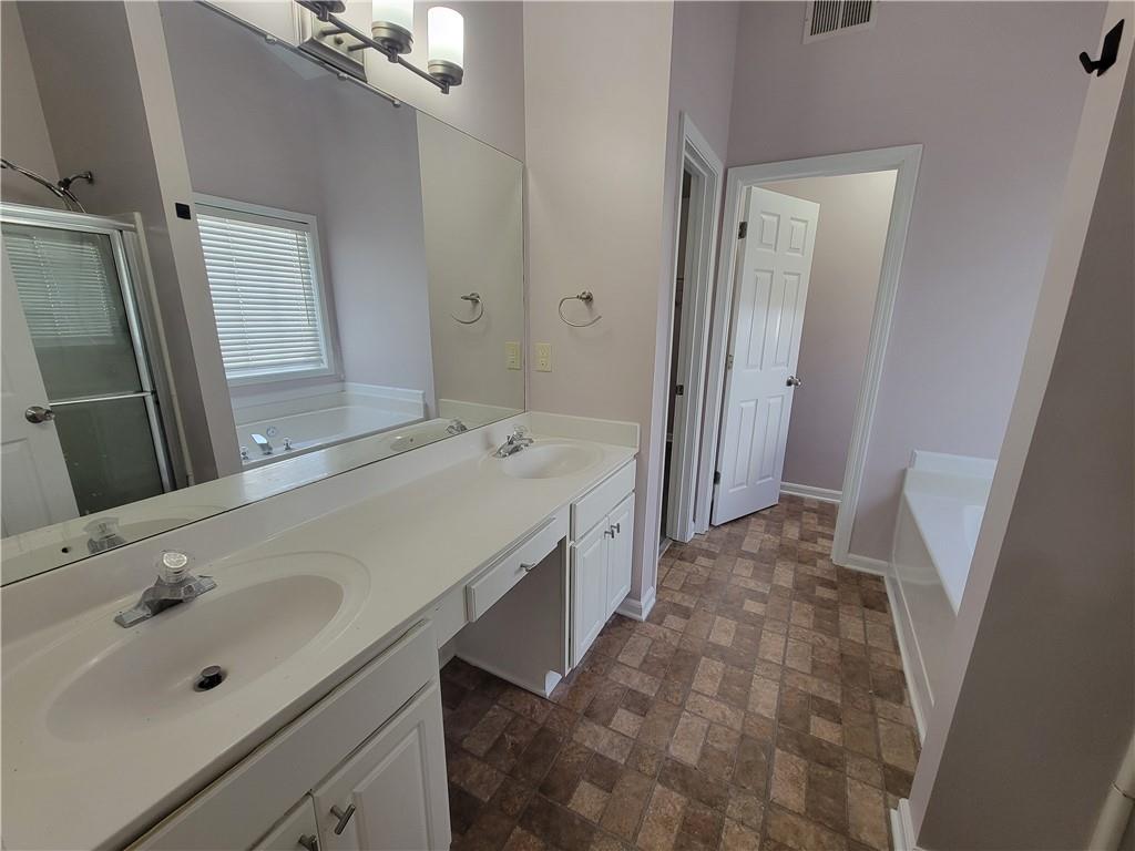 2213 Carlton Chase Road Dacula, GA 30019 - Photo 15 of 30 a bathroom with a sink and a mirror