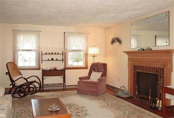 7 Scout Road Walpole, MA 02032 - Photo 3 of 17 a living room with furniture a fireplace and a window