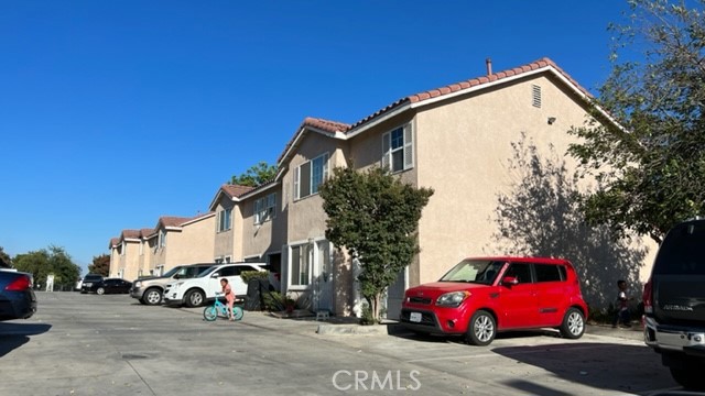 1004 South Riverside Avenue, Unit D1 Rialto, CA 92376 - Photo 1 of 14 a view of a cars parked in front of a house