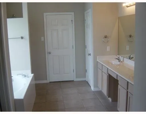 a bathroom with a double vanity sink and mirror