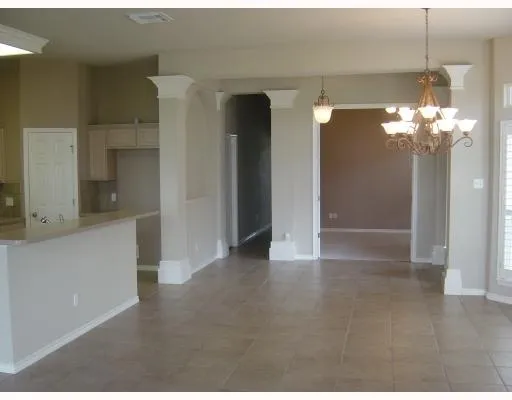 a view of a bathroom with a shower and a chandelier