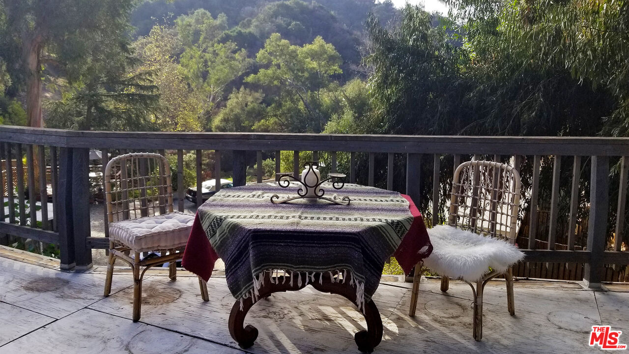 a view of a chairs and table on the deck