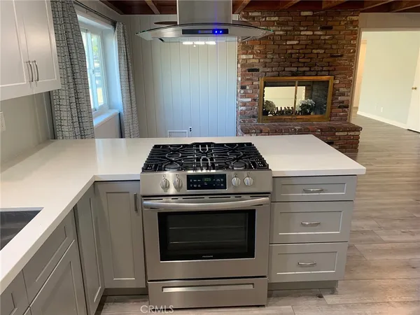 a kitchen with granite countertop a stove oven and sink
