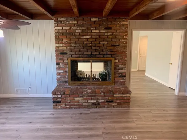 a view of fireplace with wooden floor
