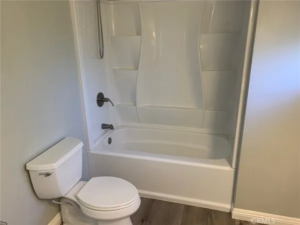 a bathroom with a toilet and a bath tub