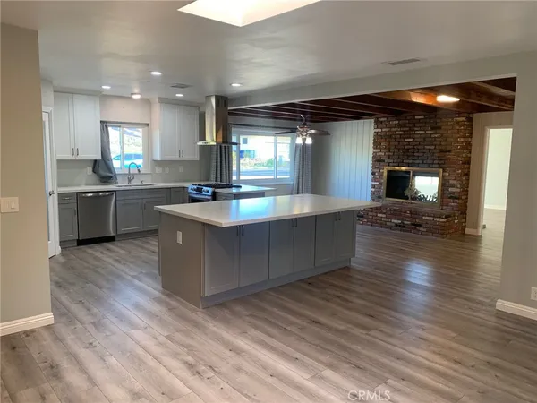 a large kitchen with stainless steel appliances granite countertop a large counter top and a stove