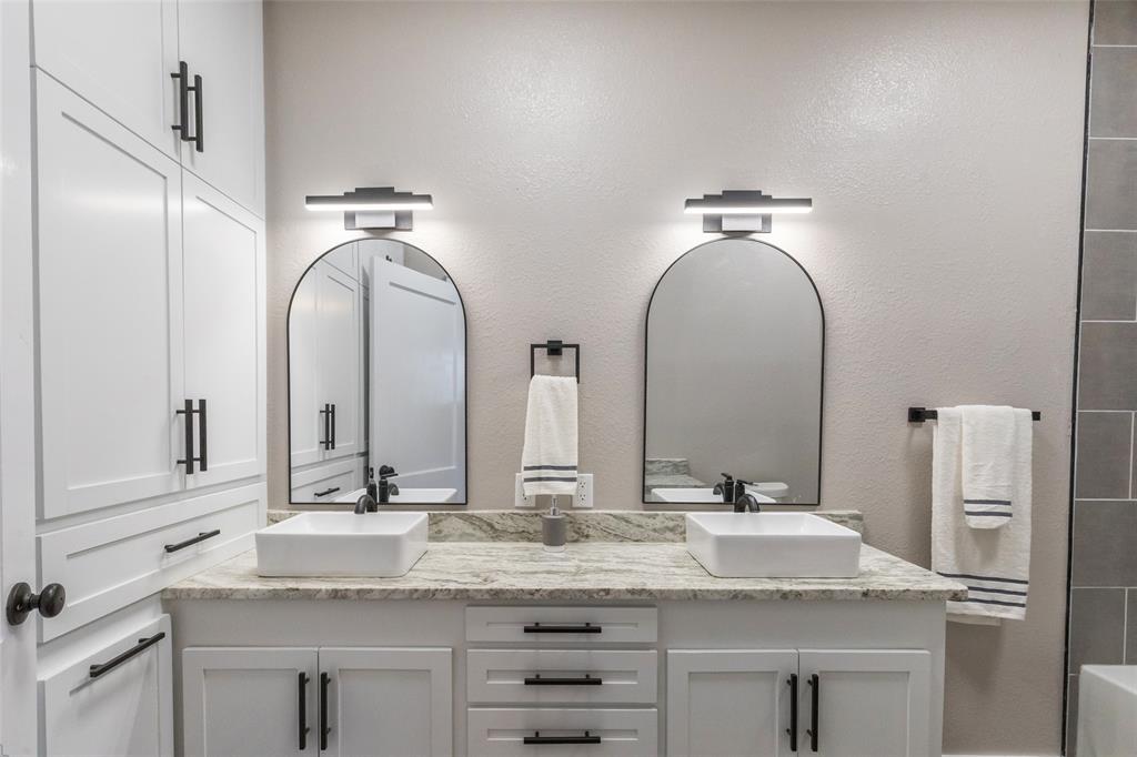 601 North Ave G Haskell, TX 79521 - Photo 22 of 36 a bathroom with a double vanity sink and a mirror