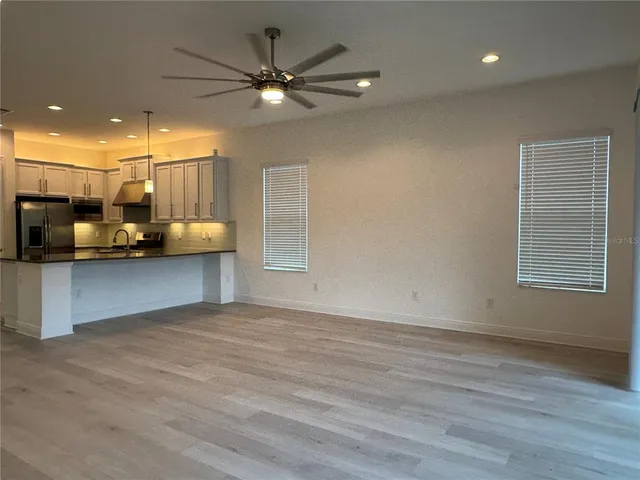 a view of a livingroom with furniture and a ceiling fan