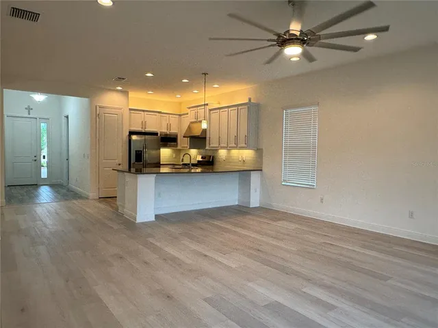 a view of a kitchen with a sink and a window