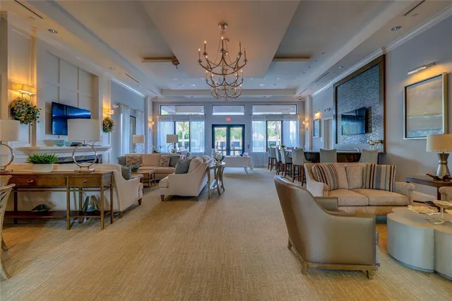 a living room with furniture a chandelier and a dining table