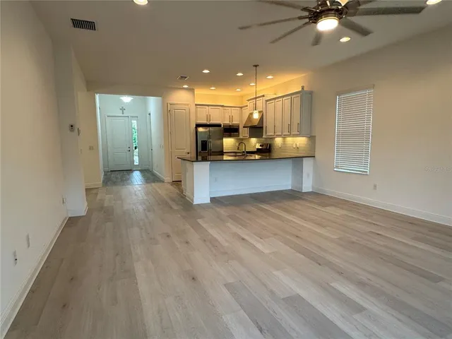 a view of a kitchen with a sink and a stove top oven