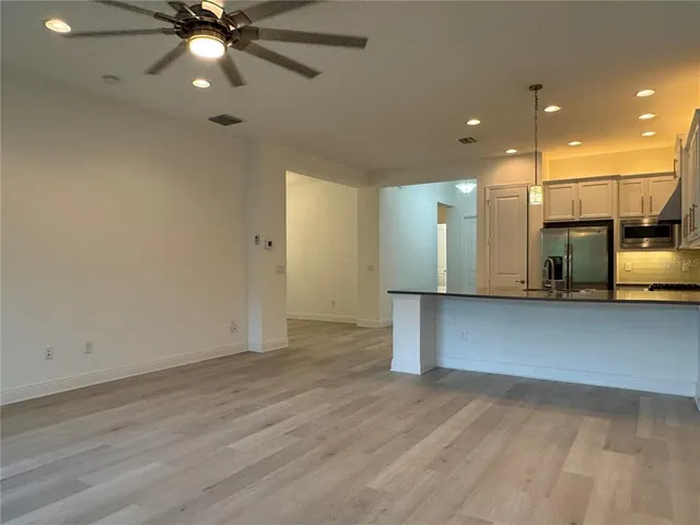 a view of a kitchen with a sink and cabinets