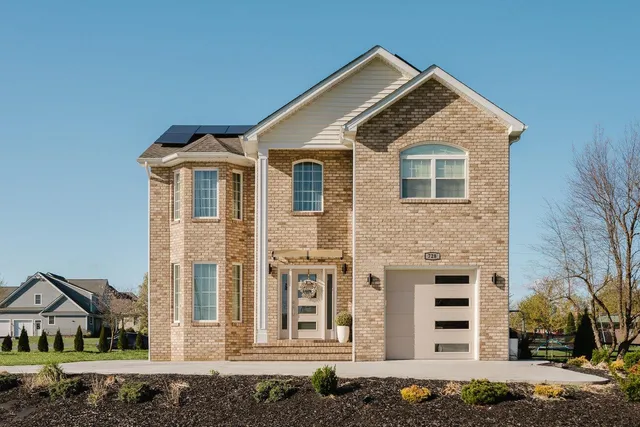 a front view of a house with a yard