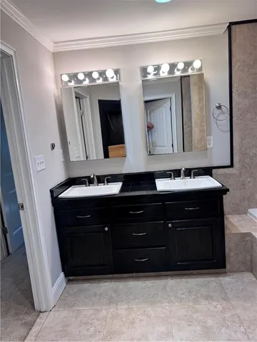 a bathroom with a sink vanity and mirror