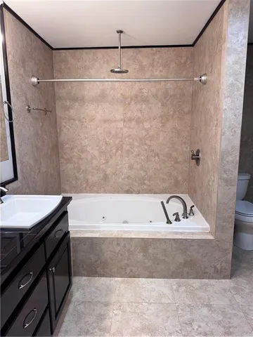 a bathroom with a bathtub and a sink