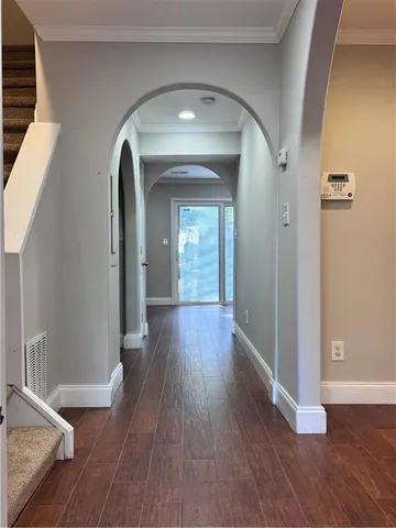 a view of livingroom with hallway and wooden floor