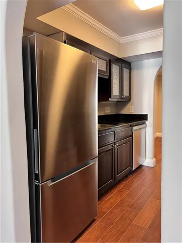 a kitchen with stainless steel appliances granite countertop a refrigerator and a sink