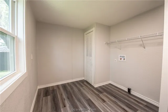 a view of small space with wooden floor and windows