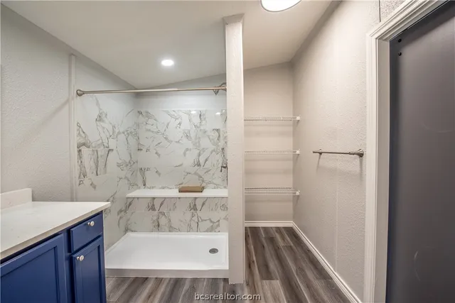 a bathroom with a bathtub and a shower