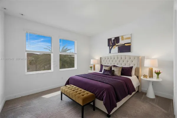 a bed sitting in a bedroom next to a window