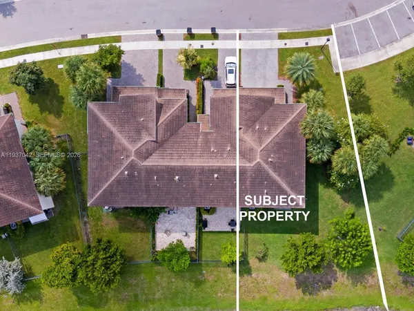 an aerial view of a house with yard