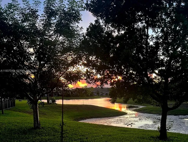 a view of yard with swimming pool and green space