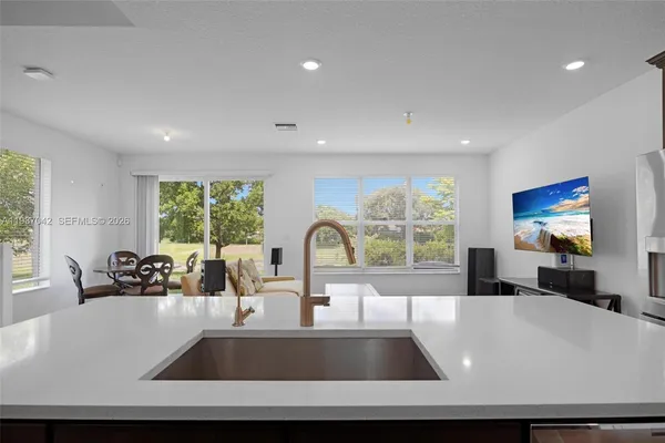 a kitchen with stainless steel appliances granite countertop a stove and a refrigerator