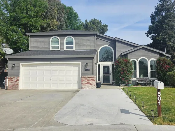 a view of a house with a yard and garage