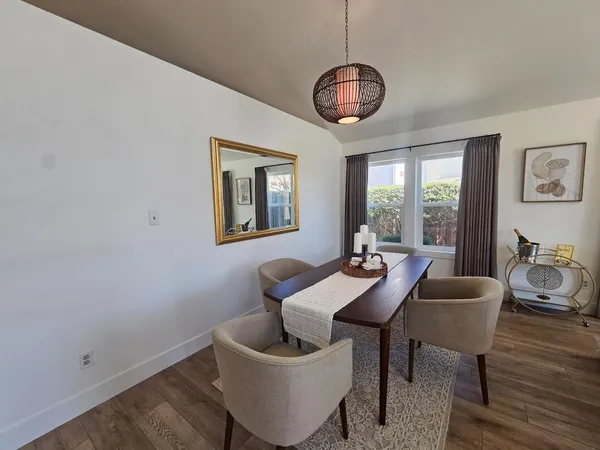 a living room with furniture a large window and a fireplace