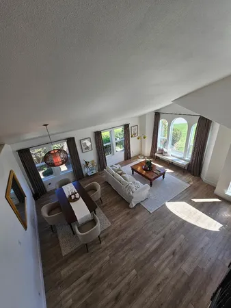a living room with furniture and a floor to ceiling window