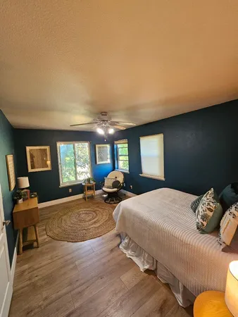 a bedroom with a large bed and a large window