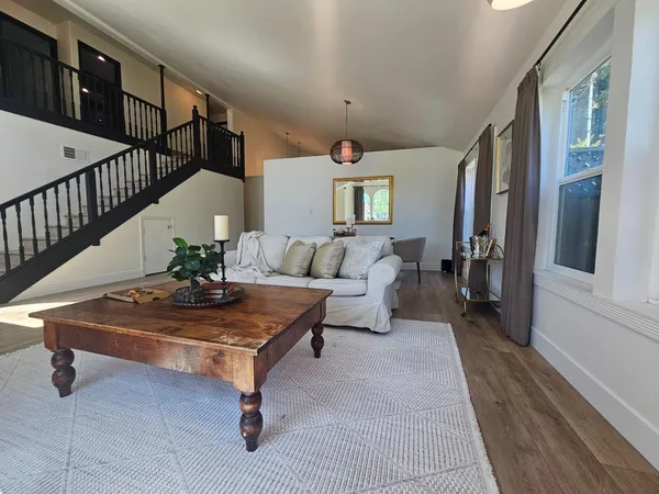 a living room with furniture and wooden floor