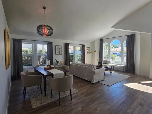 a view of a dining room with furniture and wooden floor
