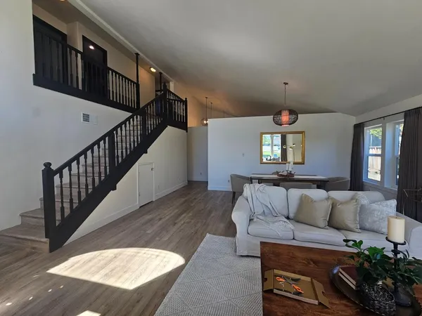 a living room with furniture fireplace and a chandelier