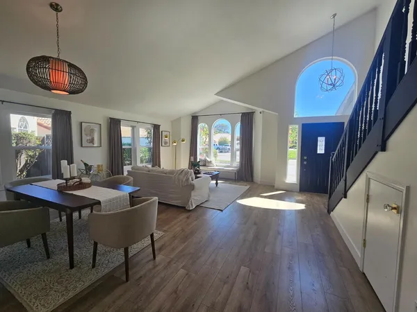 a view of a dining room with furniture wooden floor and chandelier