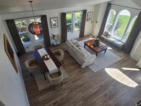 a living room with furniture wooden floor and a flat screen tv