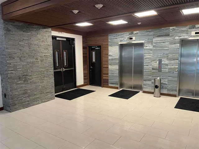 a bathroom with a granite countertop sink a large mirror and shower