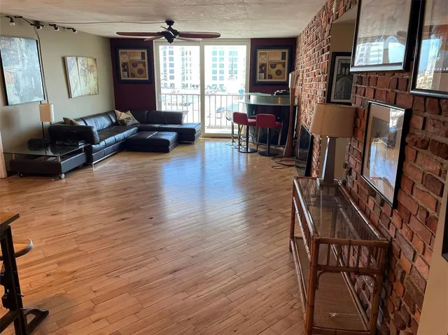 a living room with furniture a fireplace and a large window