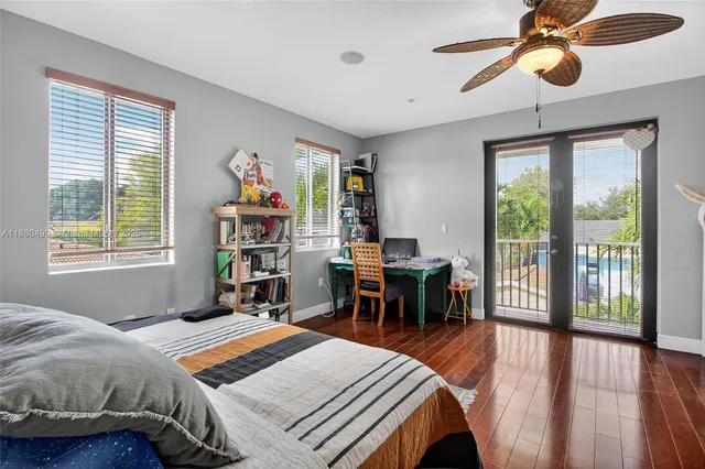 a bedroom with a bed and a large window