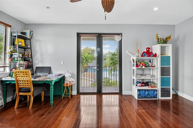 a workspace with furniture wooden floor and a window