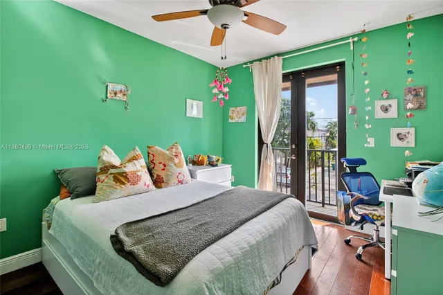 a bedroom with a bed windows and a chandelier