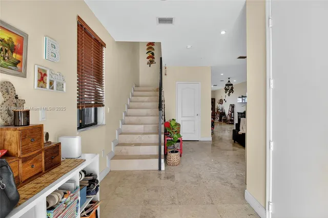 a view of a livingroom with furniture and stairs