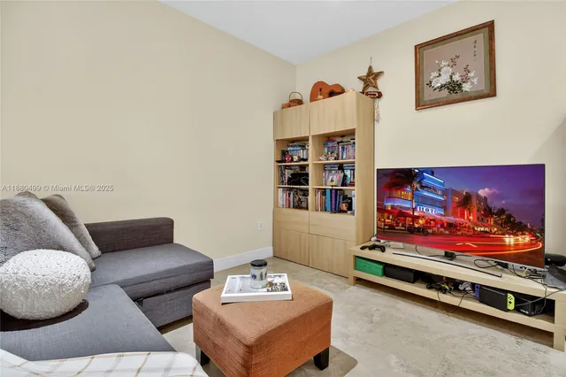 a living room with furniture and painting on the wall