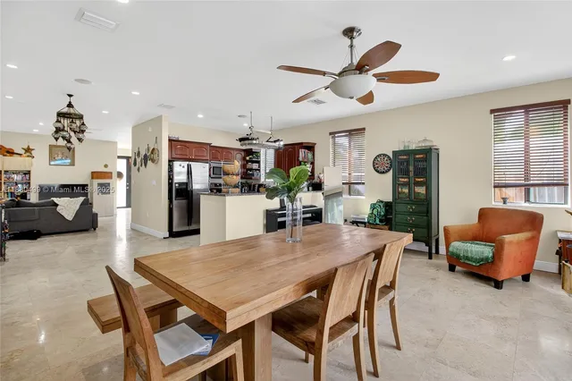 a view of a dining room with furniture and a large window