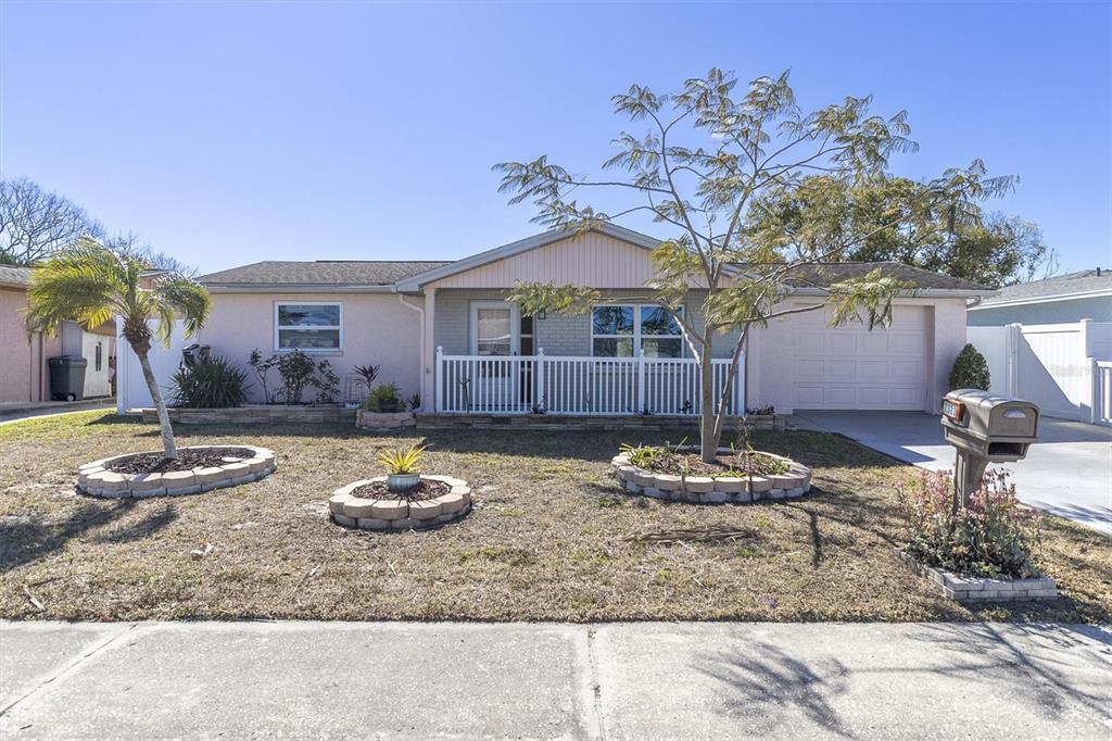 7322 Oak Crest Drive Port Richey, FL 34668 - Photo 1 of 1 a backyard of a house with a fire pit and outdoor seating