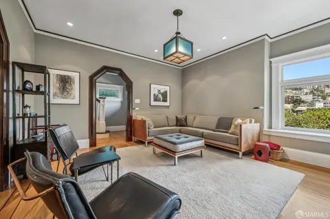 a living room with furniture a couch and a window