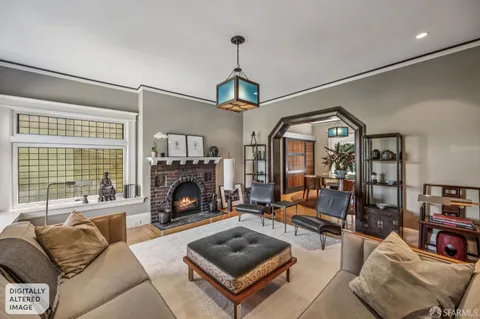 a living room with furniture a fireplace and a floor to ceiling window