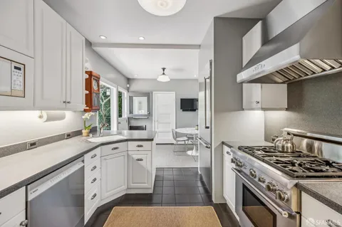 a kitchen with a stove oven and sink