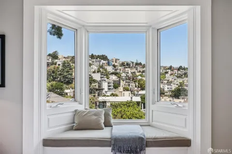 a bedroom with furniture and a window