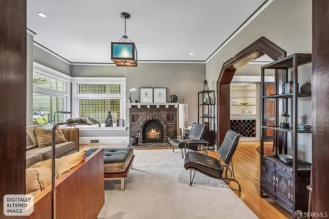a living room with furniture a fireplace and a floor to ceiling window